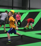 Group of people playing dodgeball on trampolines